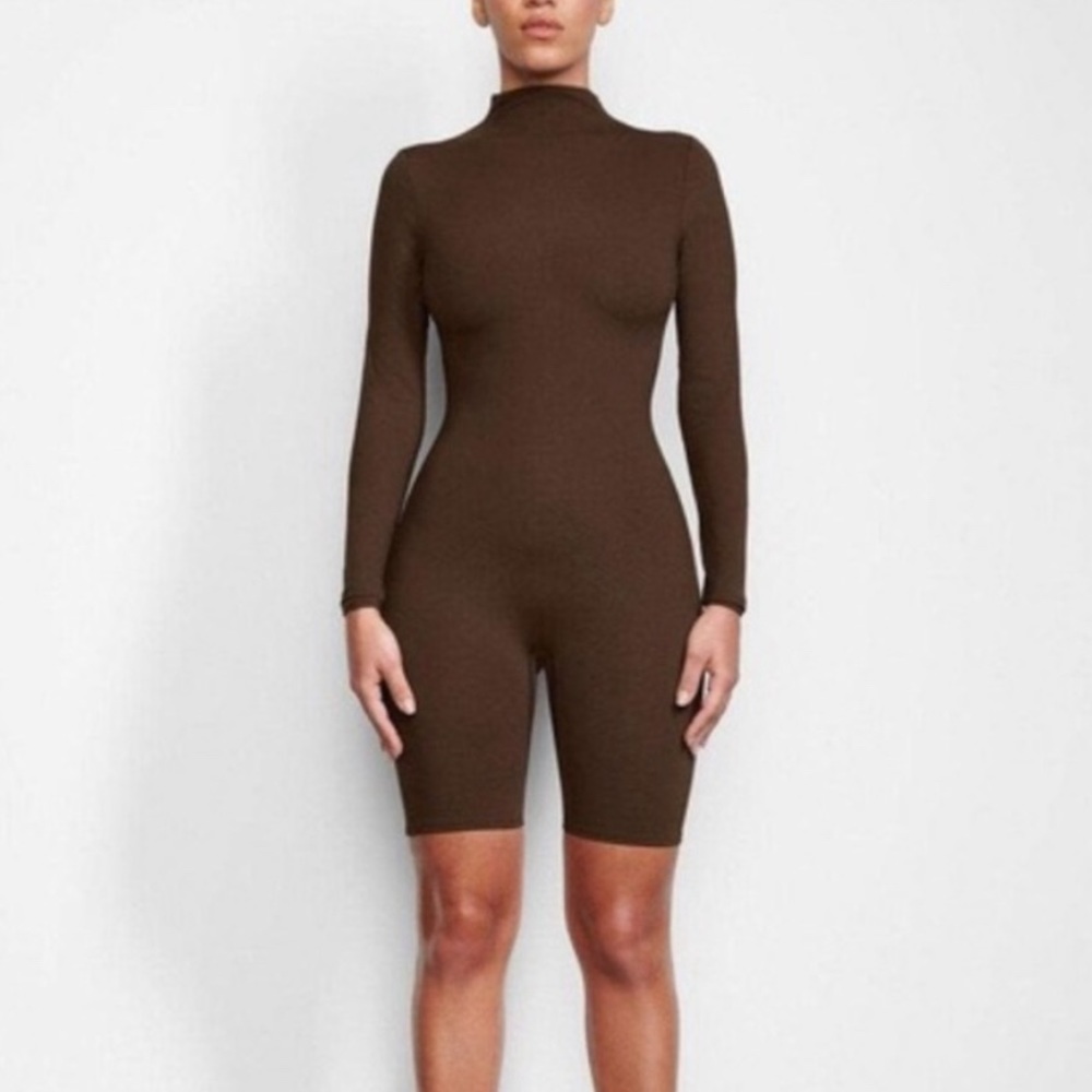 SKIMS All in One Long Sleeve Mid Thigh Onesie in Brown.